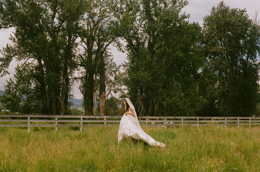 Bride walking across a field
